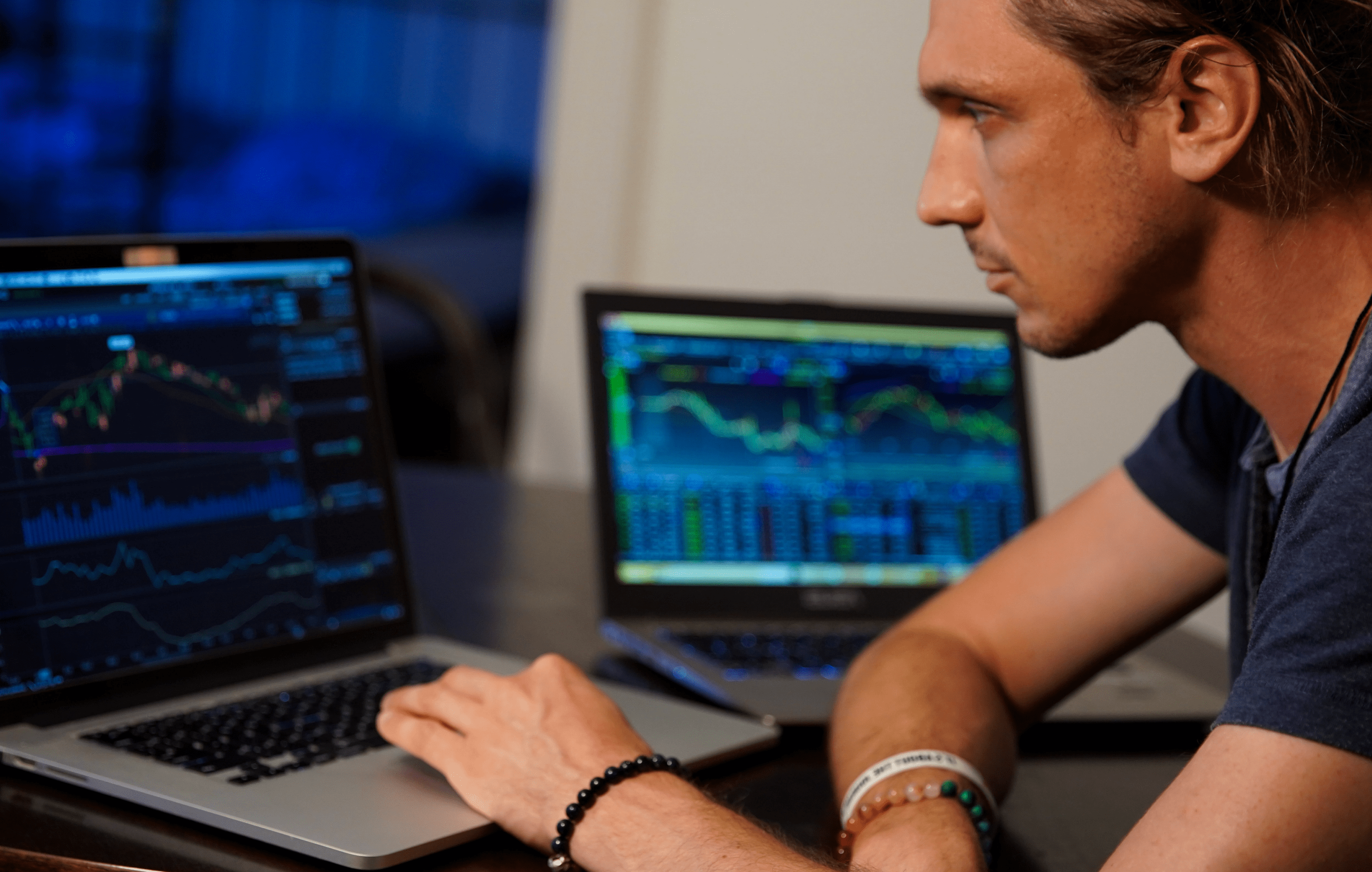 trader on laptop checking conditions